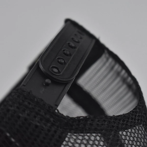 Vue macro de la fermeture snapback réglable en plastique noir d'une casquette filet
