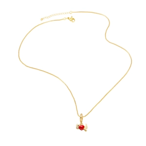 Gold necklace with winged red heart pendant on white background for women