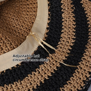 Detail of adjustable drawstring inside a wide-brimmed striped straw hat for perfect fit