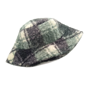 Close-up of green and grey plaid lamb wool bucket hat with soft fuzzy texture