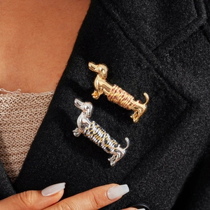 Metallic dachshund dog brooches with colorful braided cord wrap on black coat lapel