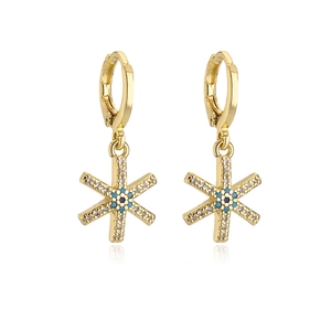 Detail of 18K gold-plated snowflake earrings featuring blue and white evil eye stones
