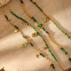 Beaded natural stone necklace with gold sun and moon charms in a vintage bohemian style
