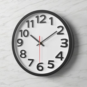 Modern 12-inch wall clock with black frame and white dial on grey marble wall