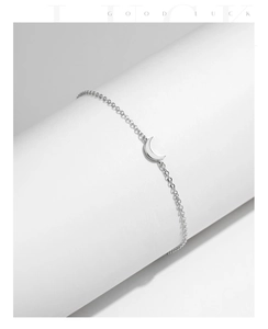 Detail of s925 sterling silver crescent moon bracelet on white display stand