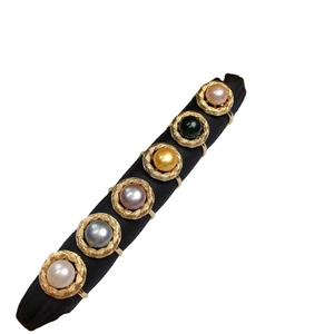 Elegant gold twisted band rings featuring diverse natural pearls in six vibrant colors