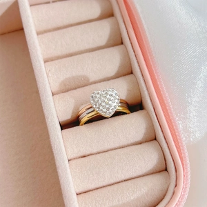 Three-tone interlaced heart ring with sparkling crystals in a pink velvet jewelry box