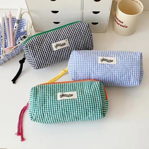 Quilted checkerboard pencil cases in blue, black, and green colors with zipper closure
