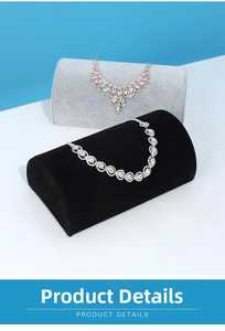 Detailed view of luxury gold and silver necklaces displayed on soft velvet cushions