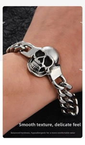 Detailed macro view of punk style skull bracelet featuring antique silver cuban links