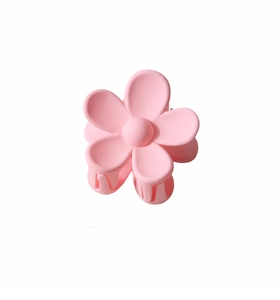 Detailed macro view of small matte pink flower hair claw clip with a resin texture finish