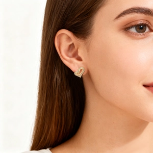 Elegant gold-plated heart stud earrings with zircon micro-paving worn by a model