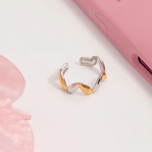 Detailed view of wave-shaped bicolor stainless steel ring with adjustable opening design