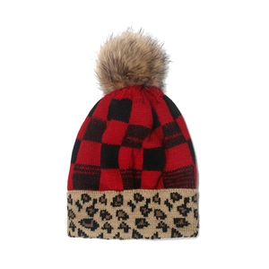 Winter knit pom pom beanie featuring buffalo plaid pattern and leopard print cuff detail