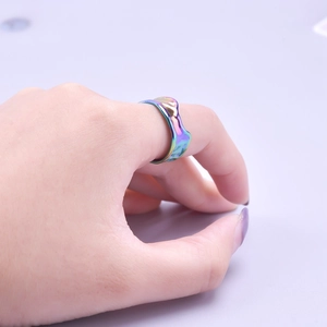 Detailed close-up of rainbow gradient finish on the irregular wavy steel ring