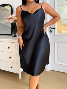Detail of elegant black silk satin sleepwear dress with thin straps and a smooth finish