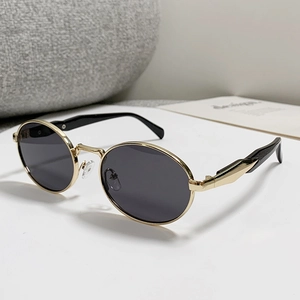 Retro oval metal frame sunglasses with dark lenses for women in a minimalist still life set
