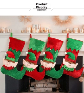 Set of four Christmas elf stockings with bells hanging on a white fireplace mantel