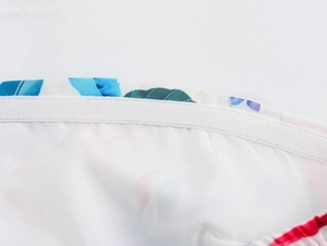 Detail of white elastic band and inner lining on floral print resort wide-leg pants