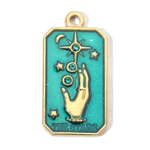 Detail of The Stars tarot pendant with green enamel, gold edges and tiny crystal accents