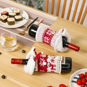 Christmas knitted wine bottle cover with reindeer and snowflake patterns and white fur trim