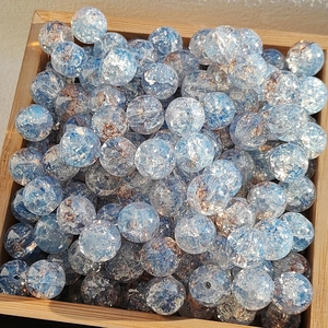 Blue and amber cracked glass beads for DIY bracelets in a wooden tray display