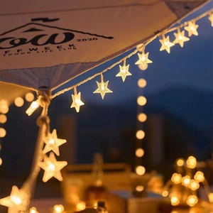 Solar powered star fairy lights for outdoor camping and garden decoration in warm white glow