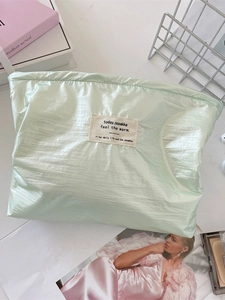 Chic mint green pleated makeup bag with metallic finish for portable storage