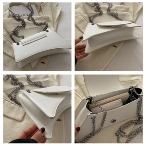 Detail showing the white chain bag's irregular geometry and internal storage capacity