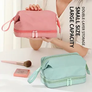 Double-layer pink cosmetic bag with large capacity and portable handle for travel storage
