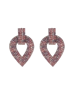 Macro view of luxurious heart-shaped earrings with pink and purple gradient crystals
