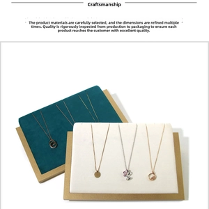 Close-up of gold and silver necklaces displayed on velvet jewelry stand boards