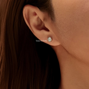 Elegant S925 sterling silver 5mm round moissanite bubble stud earring worn by a model