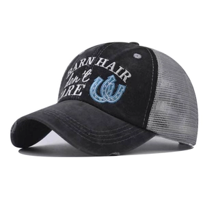 Detail of cross ponytail baseball cap with mesh back and embroidered slogan