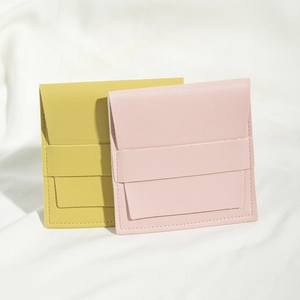 Detail of yellow and pink PU leather jewelry pouches with square flap and snap button