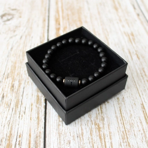 Black matte beaded Aries zodiac bracelet displayed in a matching black square gift box