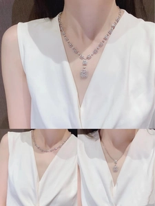 Luxury silver necklace with square iced-out pendants worn by model in a multi-angle view