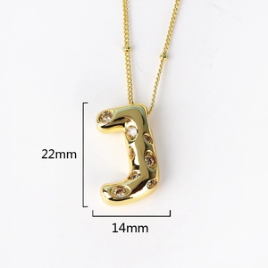 Detailed view of gold letter J pendant with cubic zirconia, size 22mm by 14mm