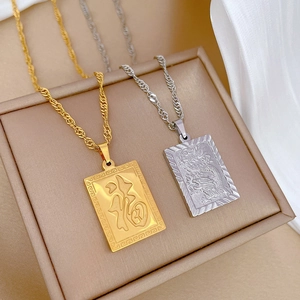 Detail of gold Fu character and silver Dragon pendant necklaces on rope chains