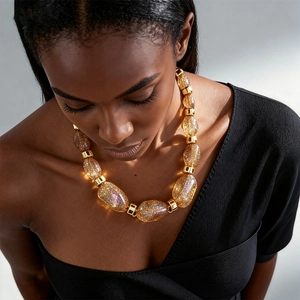 Detail of amber acrylic beads with gold leaf texture on a vintage statement necklace