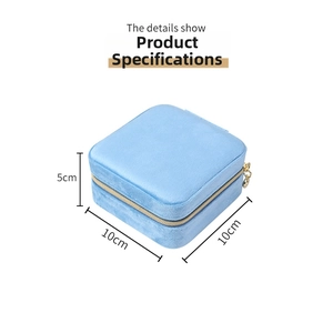 Detailed view of light blue velvet jewelry box with gold zipper measuring 10x10x5cm