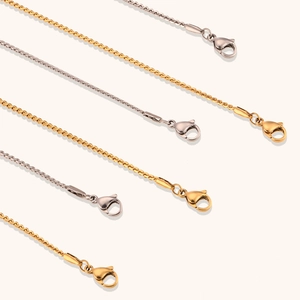 Detail view of gold and silver S-shaped wave twist chains with lobster clasps for necklaces