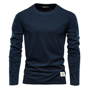 Detail of the navy cotton t-shirt neckline showing brand label and fabric texture