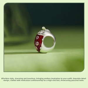 Detailed macro view of a red enamel ladybug charm bead with sparkling zirconia stones