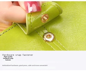 Detail of green leather wallet featuring a durable golden round metal snap button closure