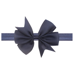 Detailed view of navy blue grosgrain ribbon bow on a soft elastic baby headband