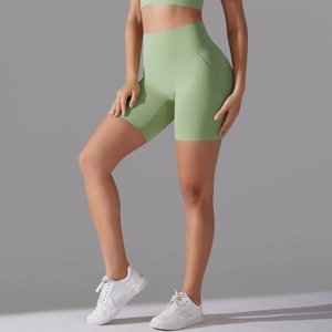 Close-up of sage green high-waist yoga shorts showing the seamless fabric and curved seams