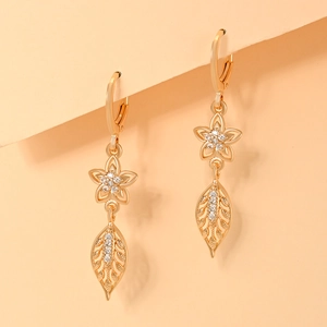 Macro detail of champagne gold flower earrings with sparkling cubic zirconia accents