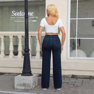 Women's high waist wide leg jeans in dark blue with cropped white top for casual wear