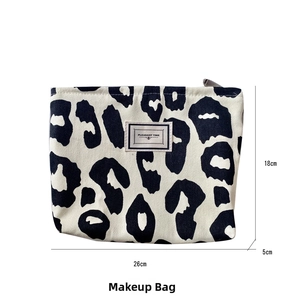 Detailed view of leopard print canvas bag with dimensions 26cm x 18cm x 5cm